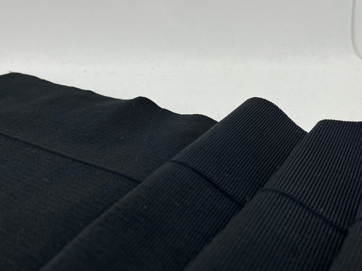 Bord-côte noir uni polyester